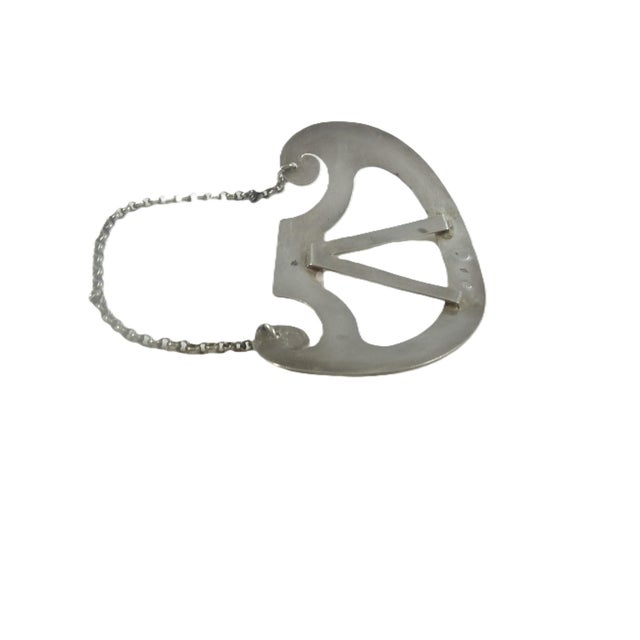 A refined large 19th-century French sterling silver .(950 standard) decanter label or ticket, crafted with restrained...