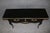 This refined French Louis XV ebonized console table is a distinguished example of classic French craftsmanship, produced...