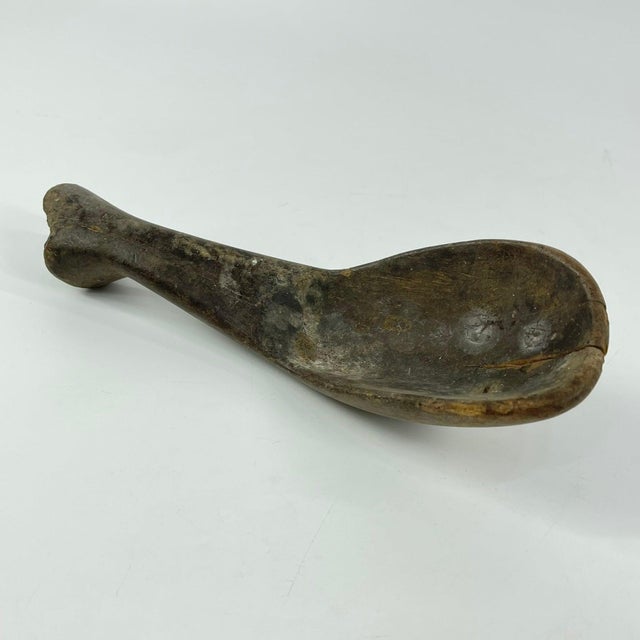 Hand-carved wooden spoon from the Lobi people of West Africa, originating from the border regions of present-day Burkina...
