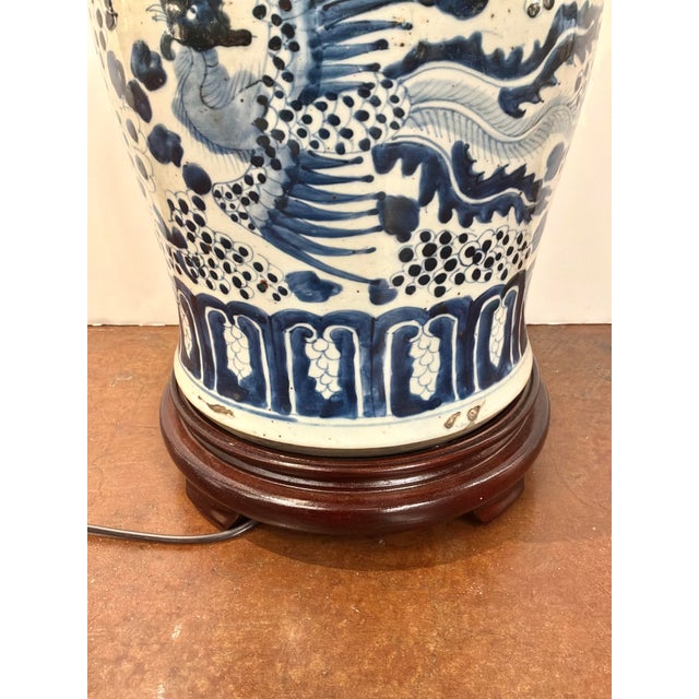 Stylish Porcelain Jar Lamp, Playing Foo Dogs, Blue & White Glaze, wood base. Showroom floor sample.