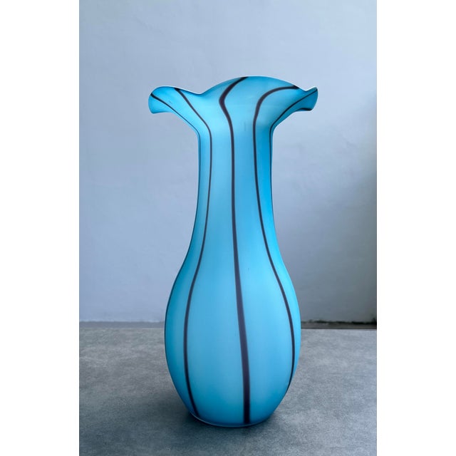 A splendidly light-hearted and graceful piece. Predominantly sky blue with wavy purple stripes and a frosted white...