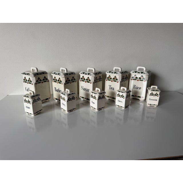 Charming vintage German ceramic canister set consisting of 10 pieces, featuring both large pantry canisters and smaller...
