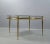Classicism coffee table made of brass with concave fluted legs and smoked glass pane. the coffee table is designed in...