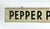 Circa 1940s two sided black and white hand lettered Pepper Plants farm stand sign with incised beveled edge. Sign has eye...