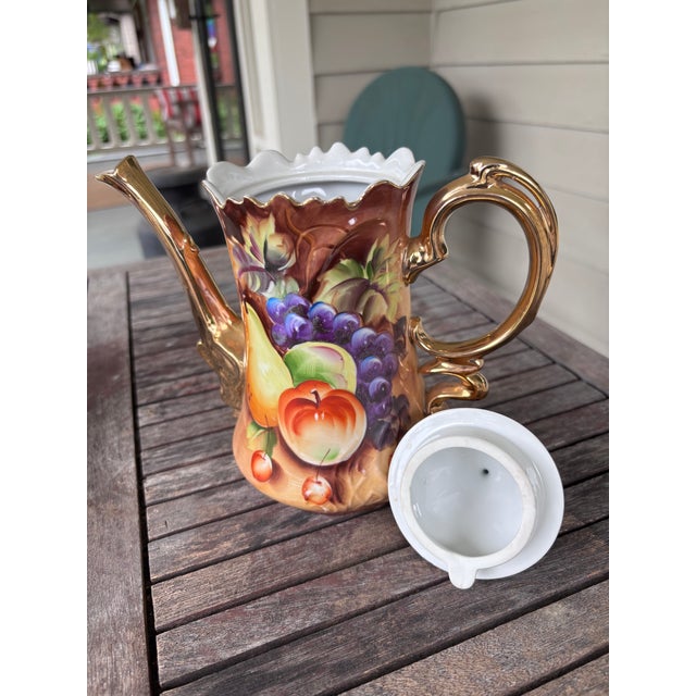 Three-piece vintage Lefton China tea set includes tea pot, creamer and covered sugar bowl. All pieces have a handpainted...