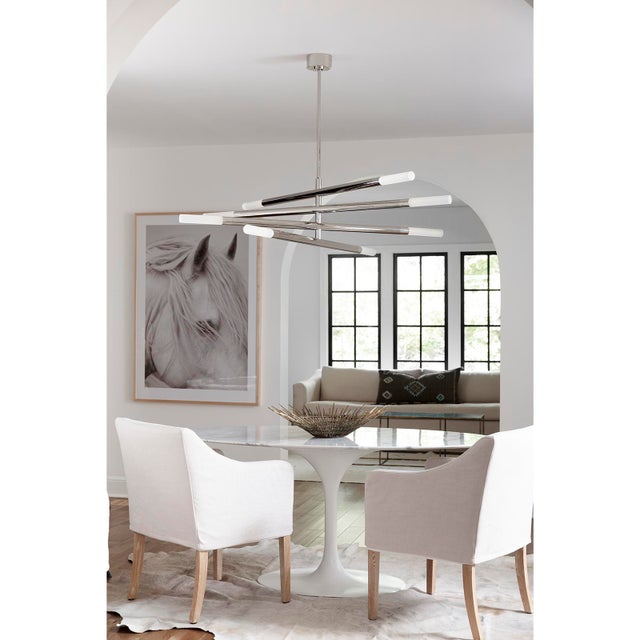 Four arms swivel around a center point on our modern, linear Wick Chandelier. Create a unique, dynamic design in your...