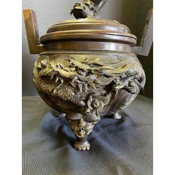 Large, heavy Chinese bronze incense burner on three decorative legs ending in an animal paw. The principal side of the...