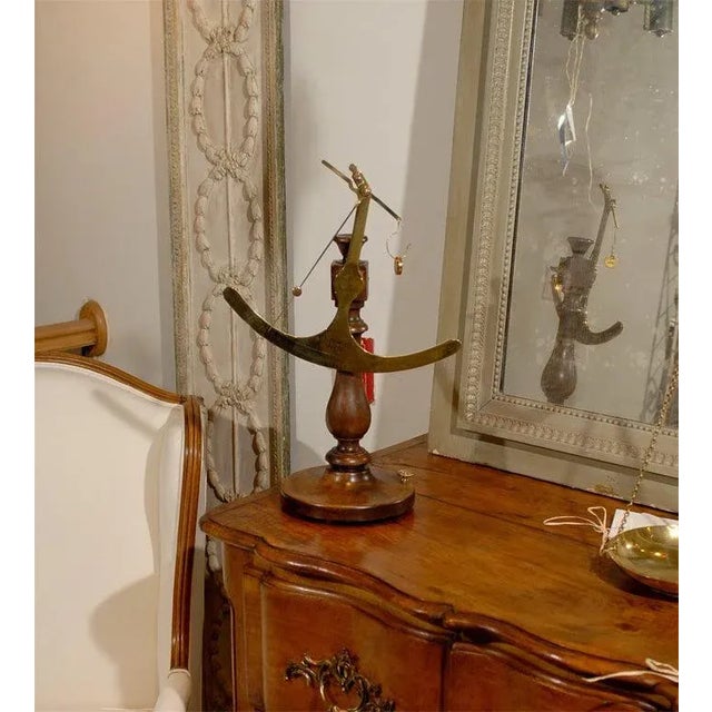 A French brass fabric scale from the 19th century with wooden base, from the Maison Piat. Created in Paris during the 19th...