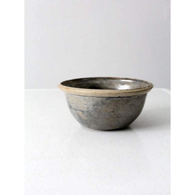 This is a vintage studio pottery bowl. Signed by the artist, the handmade bowl has a stunning taupe and blue-gray swirling...