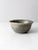This is a vintage studio pottery bowl. Signed by the artist, the handmade bowl has a stunning taupe and blue-gray swirling...