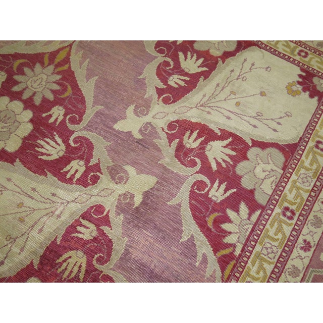 A rather unique Turkish rug with beautiful burgundy, pink and lavender colors. The graphic and design on this rug make it...