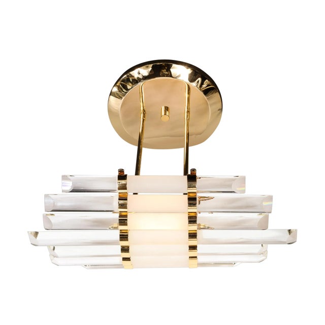 Mid-Century Modernist skyscraper style glass rod chandelier with brass fittings. This skyscraper style chandelier features...