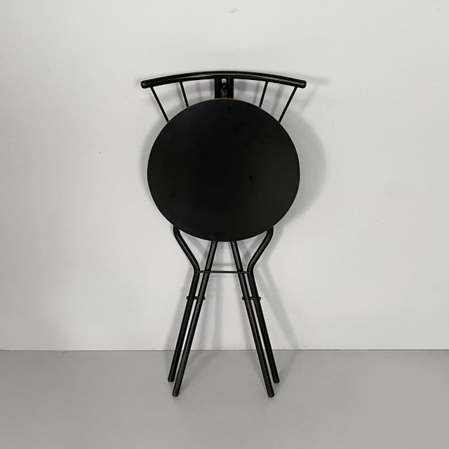 Italian modern folding chair in black wood and metal, 1980s Folding chair with round seat in black-painted wood. The...