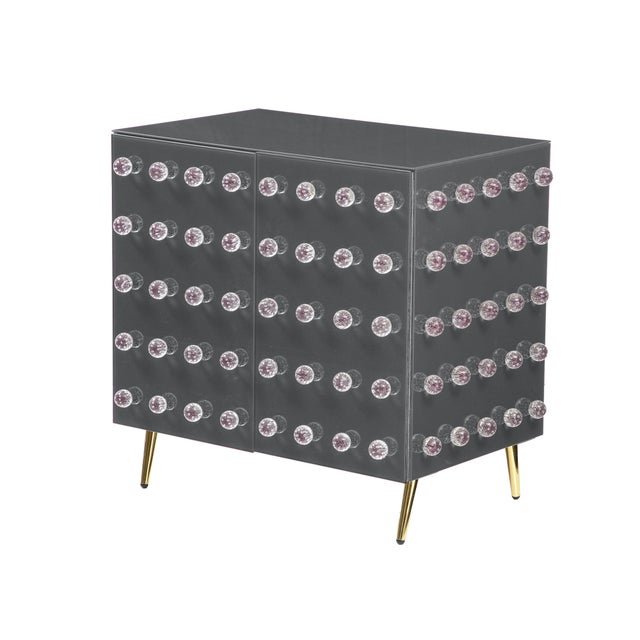 This kitchen cabinet features a jewelry-inspired design crafted from fine glass and a handcrafted birch wood frame with...