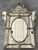 The crest top Venetian mirror. With its beveled panels and carved crest topped with a lovely lotus flower-like motif, the...