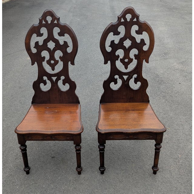 Dating back to the early 1900s, these striking wooden side chairs showcase the dramatic architectural influence of the...