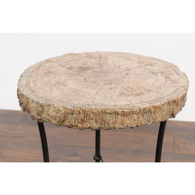 A large French faux-bois stone side table from the early 20th century mounted on a custom iron base. This French side...