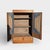 Early 20th century Japanese refinished wood cabinet with a compact vertical form, figured panel fronts, and fabric-backed...