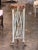 Three square tapered uprights with gilt paw feet and small gilt mask mounts, joined by crossed rods with gilt rosettes,...