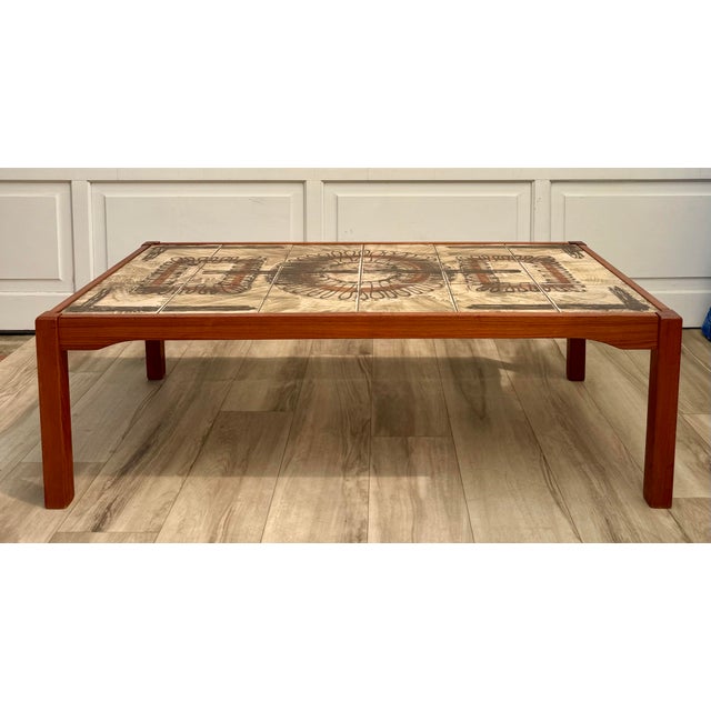 Here is a fabulous 1960-1970s Danish Modern coffee table featuring a wonderfully graphic ceramic tile top set within a...
