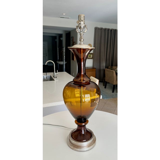 Large Swedish table lamp with root beer colored blown glass body mounted silver giltwood base. Newly wired for US with new...