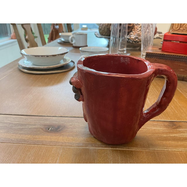 Make a bold statement with this expressive handcrafted studio pottery face mug. Featuring a dramatic, relief-molded "ugly...