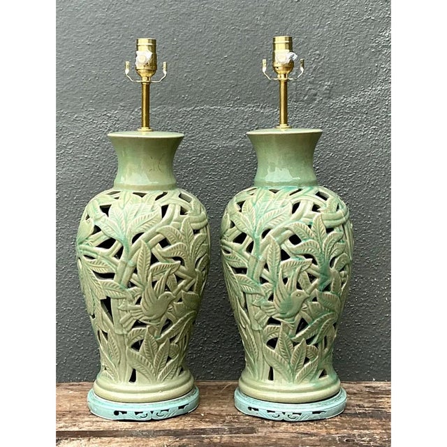 This pair of vintage porcelain table lamps showcases exceptional reticulated cutout work, with each baluster-form vase...