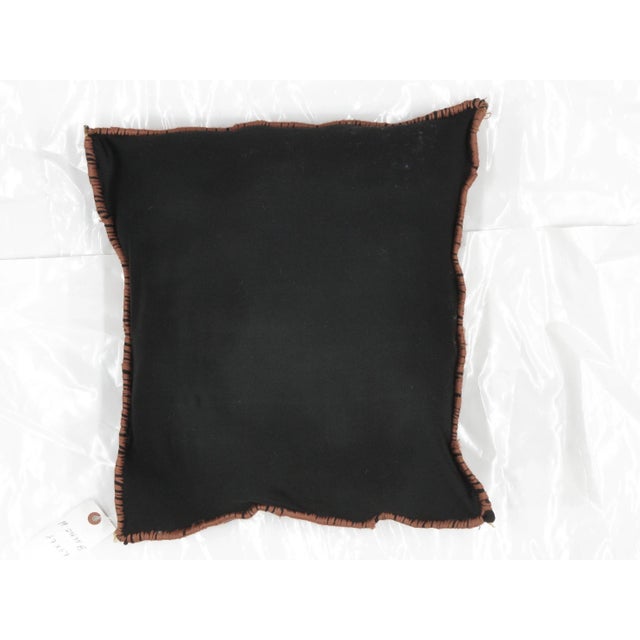 Pillow with antique Persian rug fragment. Features poly fill, fabric backing and sewn closure.