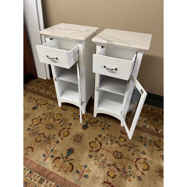 Design Plus Gallery presents a Pair of Madison Marble Top Glass Door Storage Cabinets from Elegant Furniture. Each cabinet...
