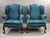 A smart pair of upholstered wingback armchairs, raised on carved cabriole legs with ball and claw feet. Each chair...