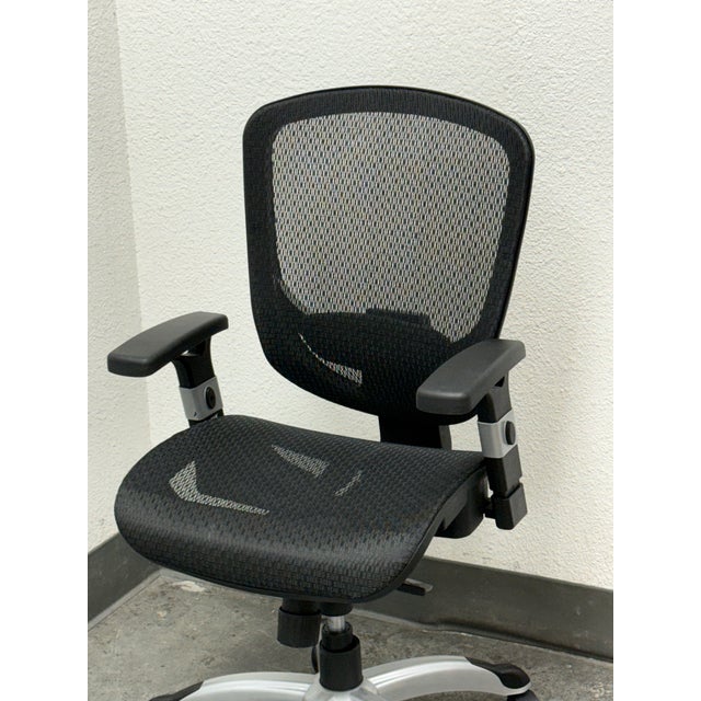 Design Plus Gallery presents a Hyken Ergonomic Mesh Swivel Task Chair. This adjustable office chair has a black mesh back...