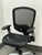 Design Plus Gallery presents a Hyken Ergonomic Mesh Swivel Task Chair. This adjustable office chair has a black mesh back...