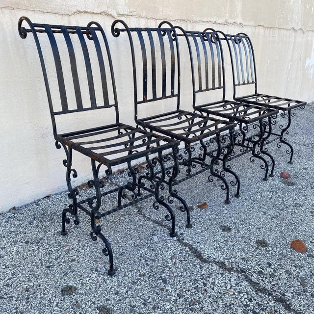 Antique French Art Nouveau Scrolling Iron Garden Patio Side Chairs - Set of 4. Circa Early 20th Century. Measurements: 34"...