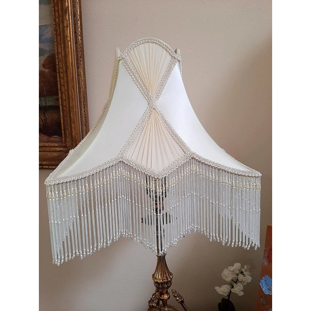 Illuminate your space with this dreamy silk beaded lampshade. It features an exquisite X-shaped pleated silk detail,...