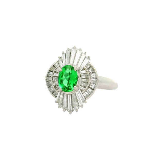 Experience the elegance of this exquisite fashion ring. At its heart lies a 0.72 carat oval Paraiba Tourmaline,...