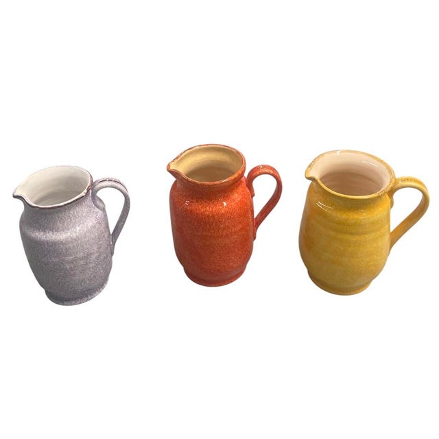 Brighten up any space with this charming set of three vintage Moroccan ceramic pitchers. Each piece is beautifully...