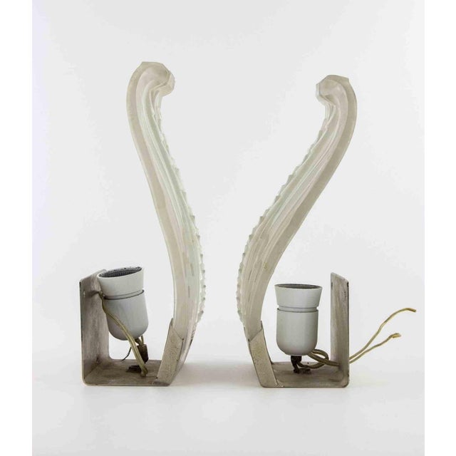 Pair of Vintage Art Deco sconces, realized in 1940s. Clear frosted glass lampshade. Each sconce accommodates one...
