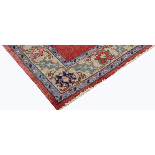 Traditional Handwoven Persian Heriz Area Rug featuring an elegant large open red field enclosed in an ivory-colored...