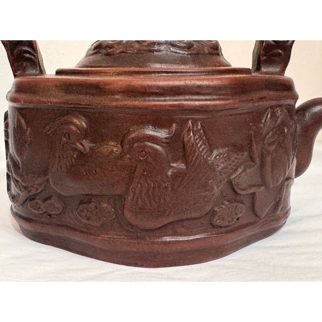 Chinese Yixing Style Red Clay Teapot with Carved Birds, Dragon Base & Figural Handle This beautifully sculpted Chinese...
