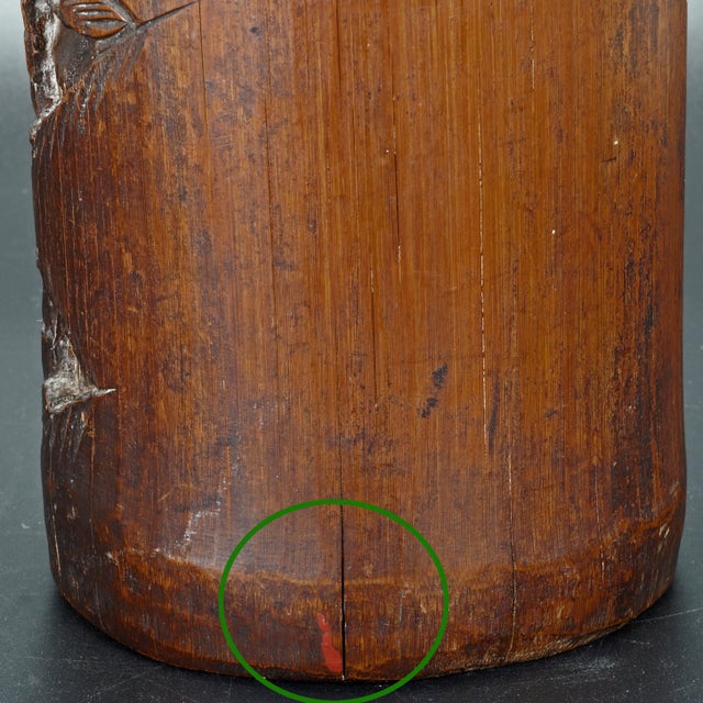 An aged dark patina bamboo that has been hollowed and carved with a design of scholars in a garden. The carving is deep...