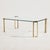 A classic-style coffee table with brass legs and a tempered glass top from 1970s France. with some surface scratches and...