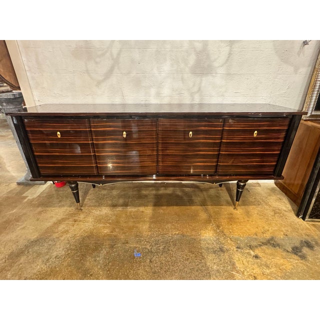 The French Art Deco Macassar Wood Sideboard is a stylish and elegant piece of furniture. Crafted from luxurious Macassar...