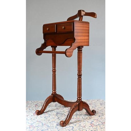 This is a gentleman’s valet stand, designed for organising clothing and accessories in a refined bedroom or dressing room...