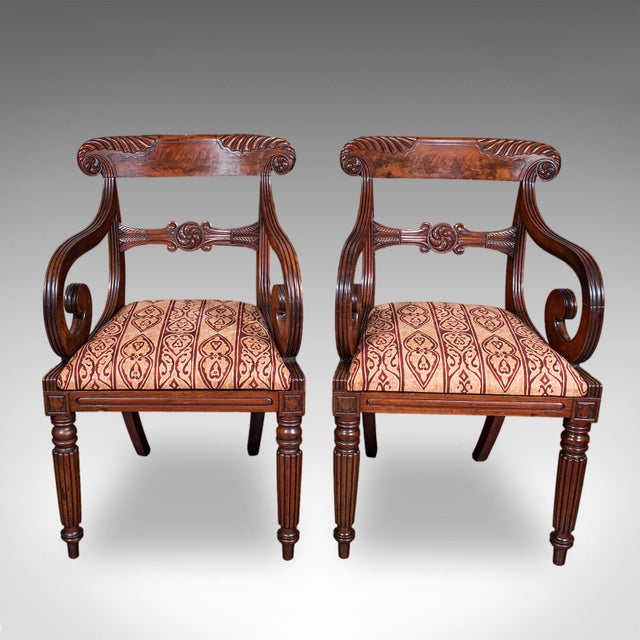 This is a pair of antique morning room elbow chairs. An English, mahogany lounge or reception hall seat, dating to the...