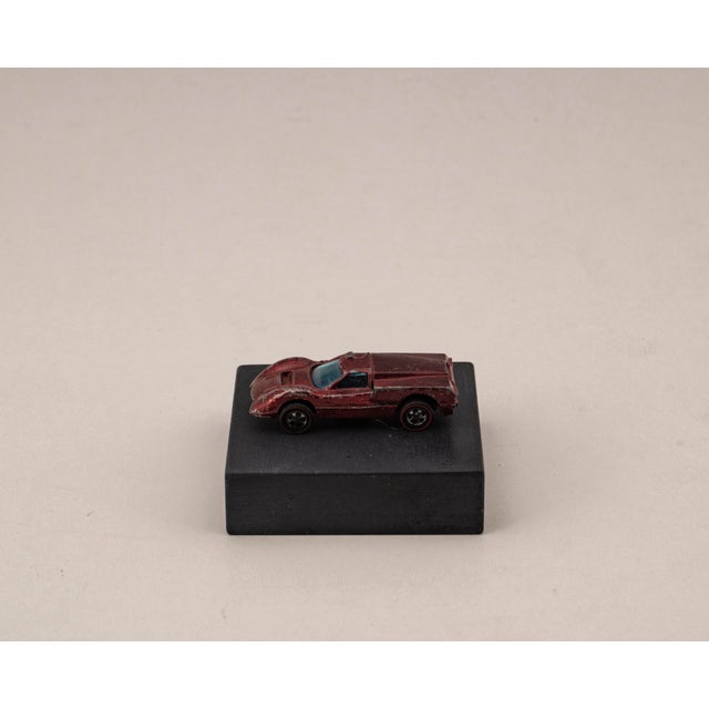 Original vintage die cast model of the per Sweet Sixteen Ford J-Car from Hot Wheels, mounted on a solid marble base. A...