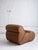 Italian mid-century lounge chair in cognac leather upholstery. This piece features a space-age silhouette and wide tufts...