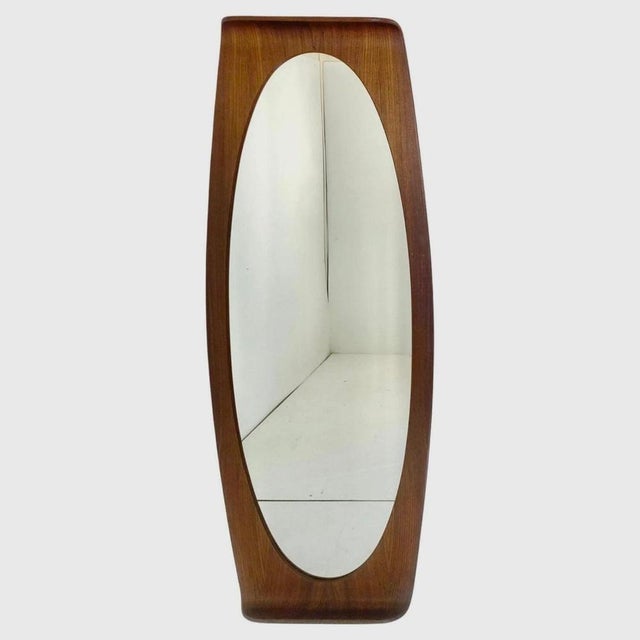 large oval mirror with curved wooden frame veneered in rosewood. Produced in Italy in the 1950s and designed by the Campo...