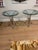 High-quality pair of round glass side tables with heavy steel bases and brass decoration. Made in France in the 1960s....