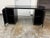 Design Plus Gallery presents the Reid Oval Black Wood Storage Desk by Mermelada Estudio for CB2. This desk has an oval...