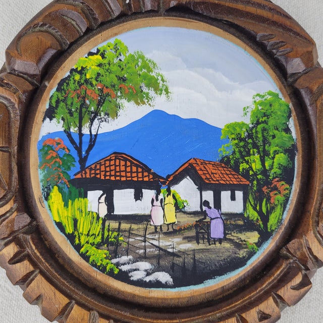 Vintage hand-painted folk art wall plaque featuring a vibrant village scene with figures, traditional white-walled houses...